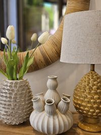 Decorative Mediterranean interior styling with handcrafted ceramics, natural textures, sculptural table lamp and round mirror in Decorative Mediterranean interior styling with handcrafted ceramics, natural textures, sculptural table lamp and round mirror in