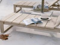 Solid wood outdoor sun loungers on minimalist Mediterranean terrace