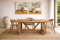Solid wood dining table with natural sisal rug in Mediterranean Mallorca interior with warm light and handcrafted details