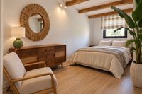 Relaxed bedroom in a Santa Catalina penthouse with natural wood, soft cotton bedding and warm Mediterranean details.