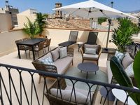 Rooftop penthouse terrace in Palma Old Town with outdoor lounge, dining area and Mediterranean city views designed for relaxed o Rooftop penthouse terrace in Palma Old Town with outdoor lounge, dining area and Mediterranean city views designed for relaxed o