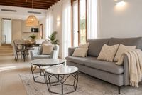 Open-plan living and dining area in a Santa Catalina townhouse in Palma with soft neutral textiles, Mediterranean natural light, modern kitchen and relaxed contemporary interior styling.