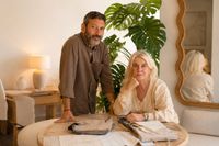 LifestyleMallorca founders working with fabrics and interior materials in relaxed Mediterranean showroom atmosphere.