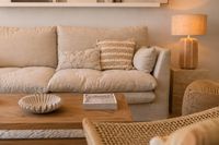 Warm Mediterranean living room with linen sofa, wooden coffee table and natural textures in calm contemporary style. Warm Mediterranean living room with linen sofa, wooden coffee table and natural textures in calm contemporary style.
